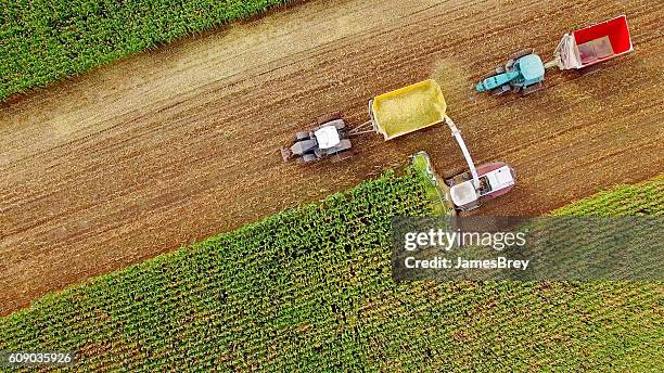 farm machines harvesting corn in september, aerial view - harvesting corn stock pictures, royalty-free photos & images