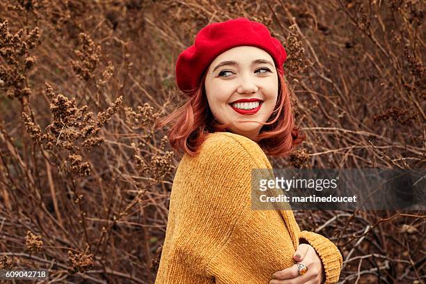 beautiful young woman enjoying autumn wind in nature. - sweater weather stock pictures, royalty-free photos & images