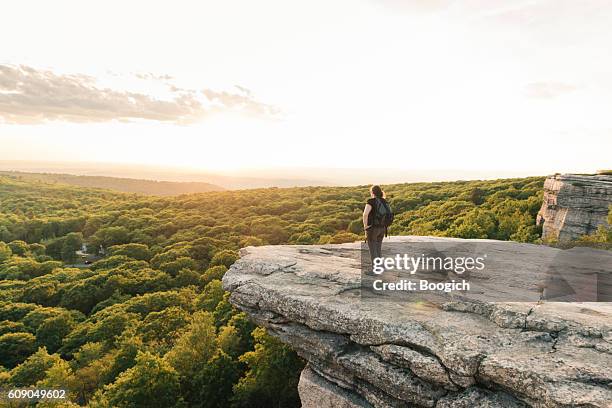 wanderlust adventure hiking woman enjoys sunset catskills mountain view ny - appalachia mountains stock pictures, royalty-free photos & images