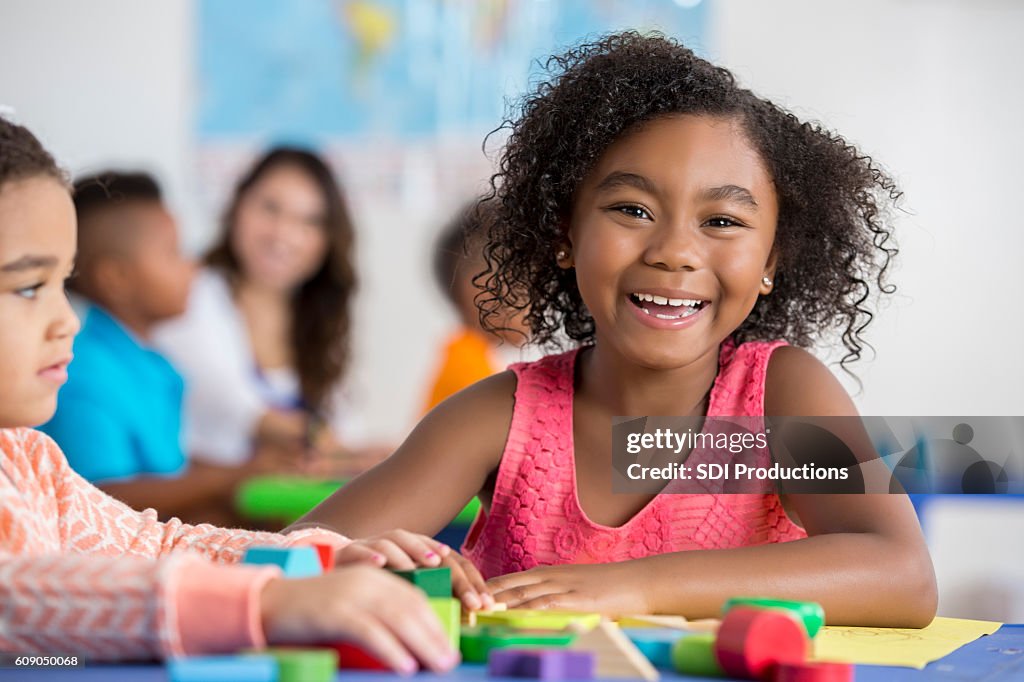 Cheerful girl works on project at school