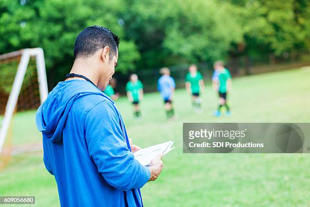 le recensioni degli allenatori fiduciose giocano durante la partita di calcio - head coach foto e immagini stock