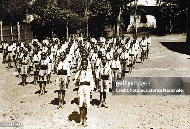Department of child soldiers of the GEL in training, barefoot and muskets on their shoulders. Photography, Ethiopia, Addis Ababa 1935 .