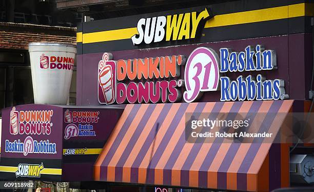 August 26, 2016: Three fast-food franchises, Dunkin' Donuts, Baskin Robbins and Subway, operate side-by-side under one roof in New York City. Dunkin'...