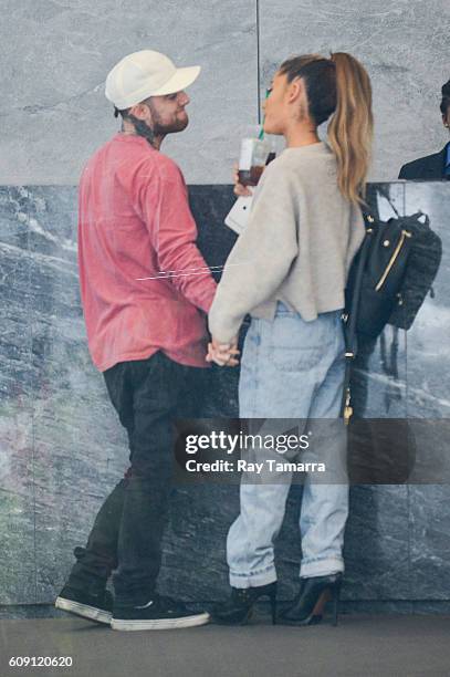 Rapper Mac Miller and singer Ariana Grande enter the Sirius XM Studios on September 20, 2016 in New York City.