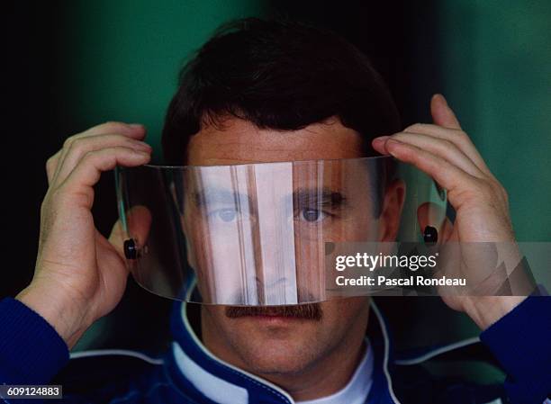 Nigel Mansell of Great Britain, driver of the Canon Williams Renault Williams FW14 Renault RS3C V10 looks through his visor before the the Canadian...