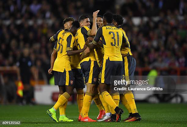 Granit Xhaka of Arsenal celebrates scoring the opening goal with team mates during the EFL Cup Third Round match between Nottingham Forest and...