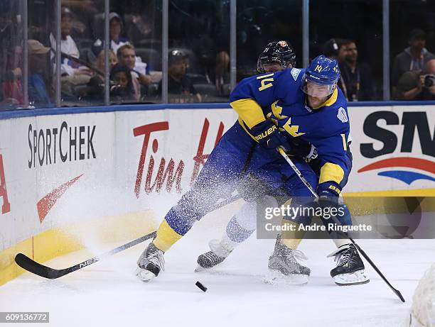 Mattias Ekholm of Team Sweden battles for the puck with Leo Komarov of Team Finland during the World Cup of Hockey 2016 at Air Canada Centre on...