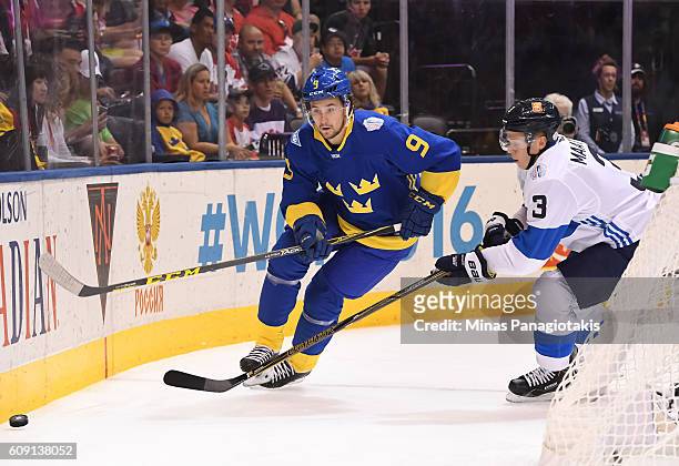 Filip Forsberg of Team Sweden stickhandles the puck away from Olli Maatta of Team Finland during the World Cup of Hockey 2016 at Air Canada Centre on...