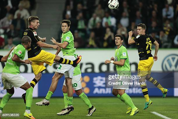 Lukasz Piszczek of Dortmund scores their first goal with a header during the Bundesliga match between VfL Wolfsburg and Borussia Dortmund at...