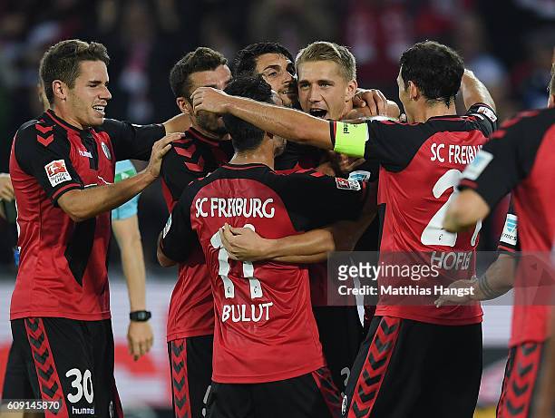 Nils Petersen of Freiburg celebrates with his team-mates after scoring his team's first goal during the Bundesliga match between SC Freiburg and...