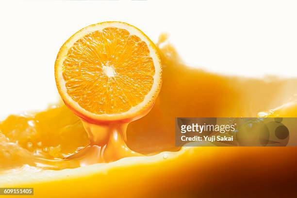 orange jump out from orange juice - juicy stock pictures, royalty-free photos & images