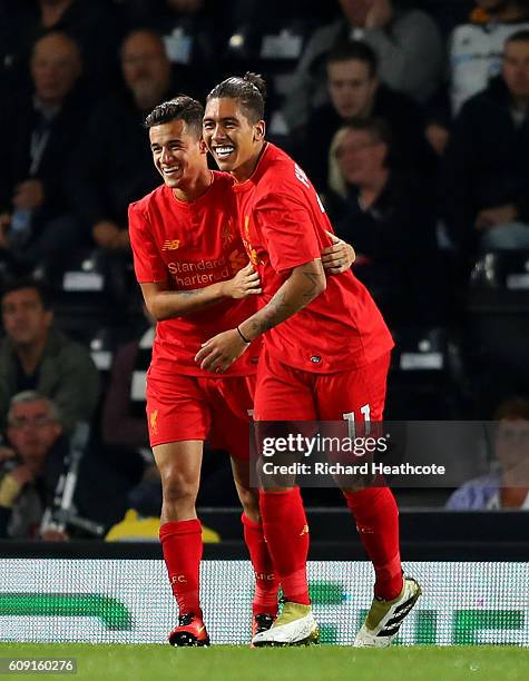 Philippe Coutinho of Liverpool celebrates scoring his team's second goal with Roberto Firmino during the EFL Cup Third Round match between Derby...