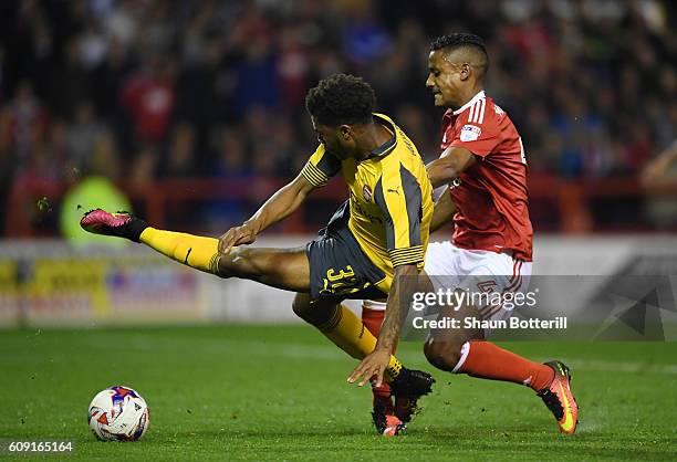 Chuba Akpom of Arsenal is brought down by Michael Mancienne of Nottingham Forest leading to a penalty during the EFL Cup Third Round match between...