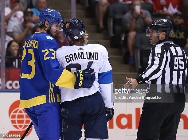 Oliver Ekman-Larsson of Team Sweden discusses his tripping penalty with Mikael Granlund of Team Finland during the World Cup of Hockey 2016 at Air...