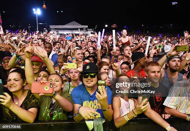 Fans watch and record the performance at Music Midtown with their cell phones at Piedmont Park on September 17, 2016 in Atlanta, Georgia.