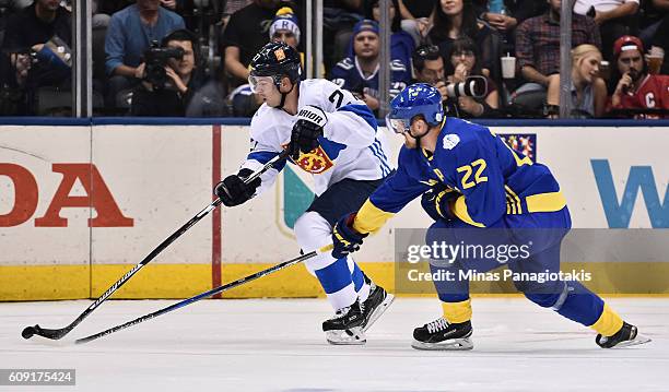 Joonas Donskoi of Team Finland stickhandles the puck with Daniel Sedin of Team Sweden chasing during the World Cup of Hockey 2016 at Air Canada...