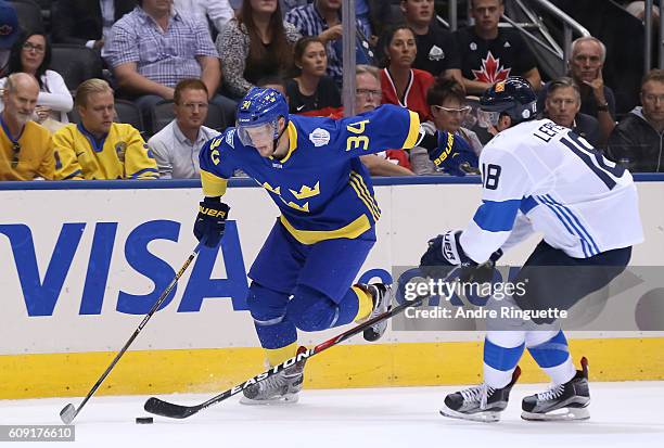 Carl Soderberg of Team Sweden controls the puck with pressure from Sami Lepisto of Team Finland during the World Cup of Hockey 2016 at Air Canada...