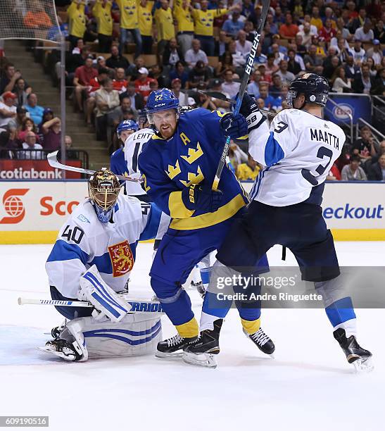 Daniel Sedin of Team Sweden battles for position with Olli Maatta in front of Tuukka Rask of Team Finland during the World Cup of Hockey 2016 at Air...