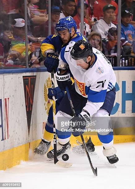 Leo Komarov of Team Finland and Niklas Hjalmarsson of Team Sweden battle for the puck along the boards during the World Cup of Hockey 2016 at Air...