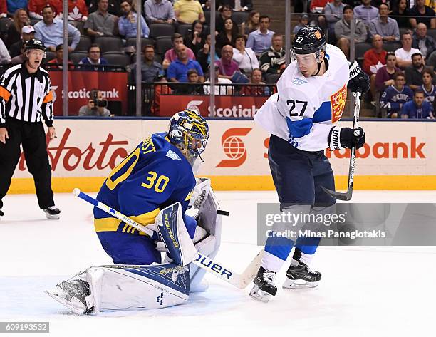 Henrik Lundqvist of Team Sweden makes a save with Joonas Donskoi of Team Finland creating traffic in front during the World Cup of Hockey 2016 at Air...