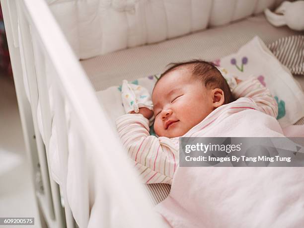 new born baby sleeping soundly in crib - baby bassinet bildbanksfoton och bilder