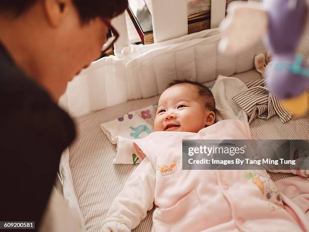 grandma talking to a new born baby joyfully - first grandchild stock pictures, royalty-free photos & images