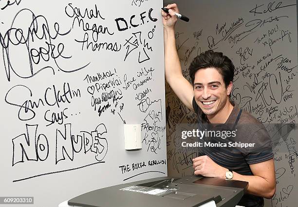 Actor Ben Feldman signs the wall at AOL HQ when he visits for The Build Series Presents Ben Feldman Discussing The Show "Superstore" at AOL HQ on...
