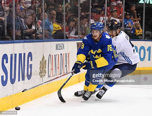Jakob Silfverberg of Team Sweden and Aleksander Barkov of Team Finland battle for a loose puck during the World Cup of Hockey 2016 at Air Canada...