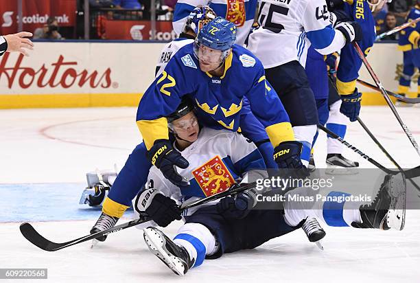 Patric Hornqvist of Team Sweden gets tangled up with Olli Maatta of Team Finland during the World Cup of Hockey 2016 at Air Canada Centre on...