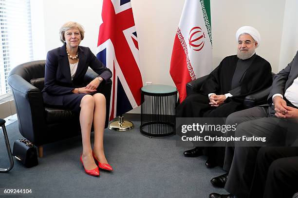 British Prime Minister Theresa May and the President of Iran, Hassan Rouhani pose as they meet before a bilateral meeting during the United Nations...