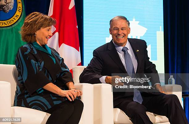 Jay Inslee, governor of Washington, right, and Christy Clark, premier of British Columbia, smile during a panel discussion at the Emerging Cascadia...