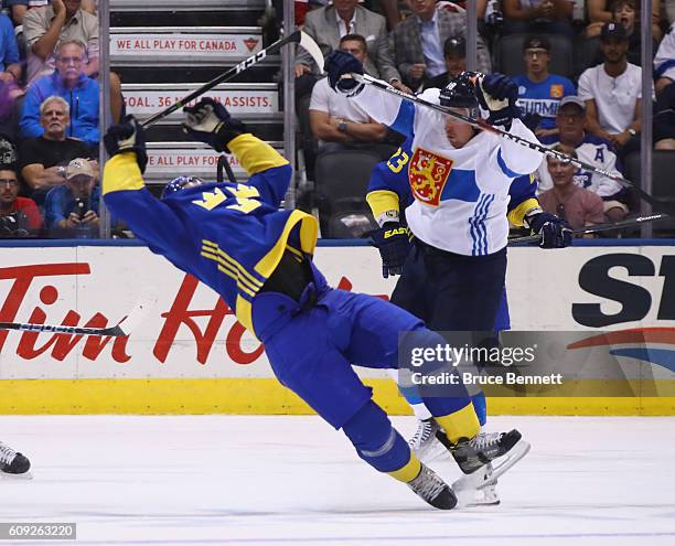 Mikael Backlund of Team Sweden is hit by Sami Lepisto of Team Finland during the third period during the World Cup of Hockey tournament at the Air...