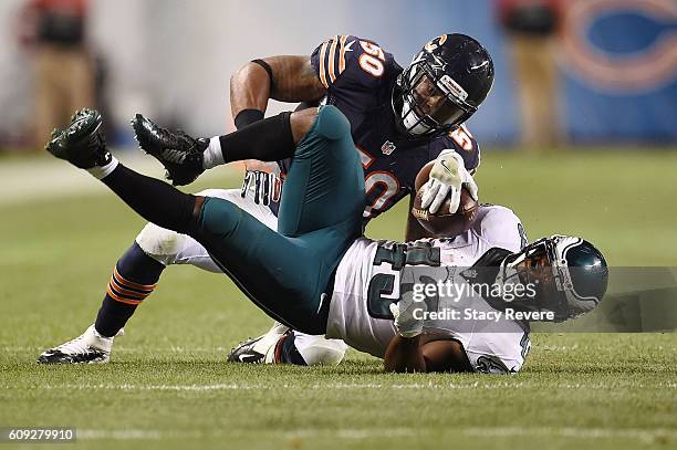 Darren Sproles of the Philadelphia Eagles is brought down by Jerrell Freeman of the Chicago Bears during a game at Soldier Field on September 19,...
