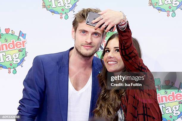 German actor Joern Schloevoigt and singer Sarah Lombardi make a selfie during the KinderTag to celebrate children's day on September 20, 2016 in...