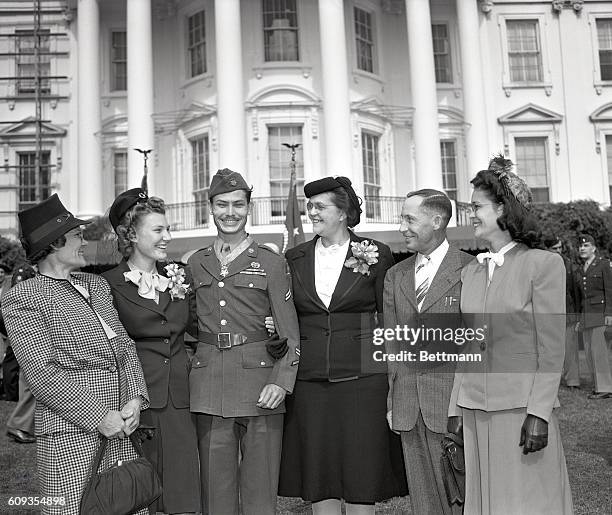 Corporal Desmond T. Doss, Lynchburg, VA, a conscientious objector, with his wife and family after ceremonies in the White House gardens during which...
