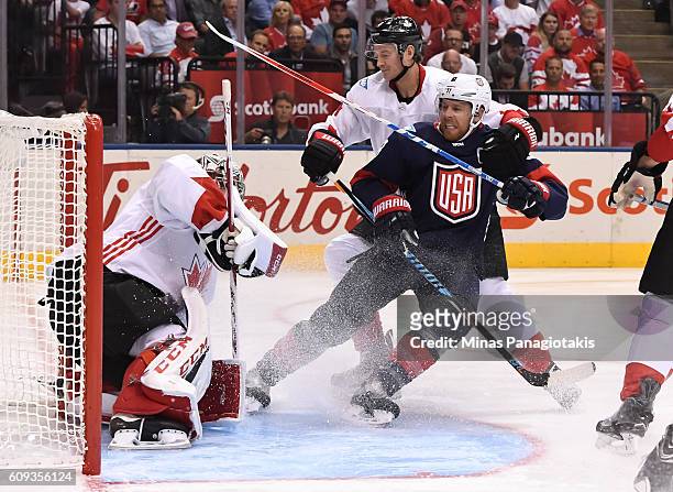 Joe Pavelski of Team USA battles for position with Jay Bouwmeester battle for position in front of Carey Price of Team Canada during the World Cup of...