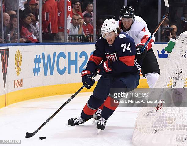 Oshie of Team USA stickhandles the puck with pressure from Jay Bouwmeester of Team Canada during the World Cup of Hockey 2016 at Air Canada Centre on...