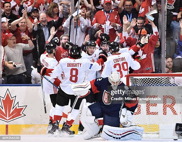 Corey Perry celebrates with Jay Bouwmeester, Drew Doughty, Jonathan Toews and Logan Couture of Team Canada after scoring a first period goal on Team...