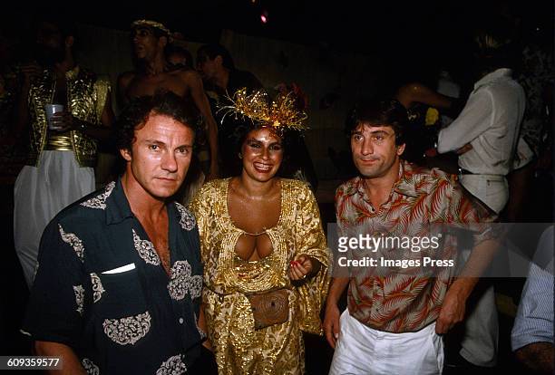 Harvey Keitel, singer Fafa de Belem and Robert De Niro attends A Carnival party in Brazil circa 1981.