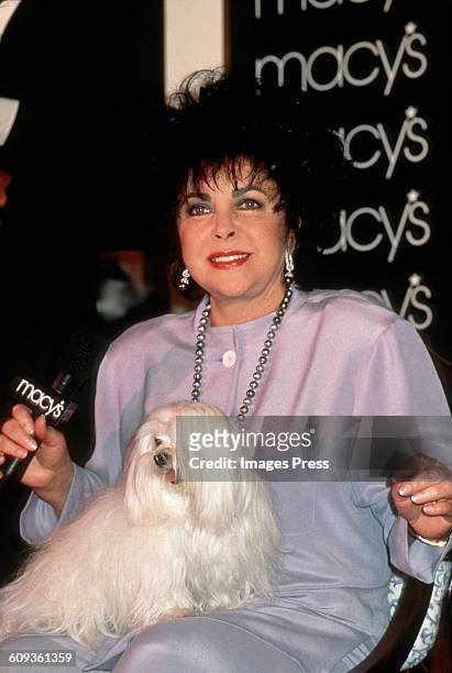 Elizabeth Taylor and her dog Sugar at a perfume launch at Macy's circa 1996 in New York City.