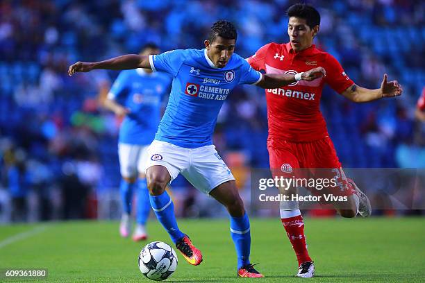 Pablo Barrientos of Toluca struggles for the ball with Joao Rojas of Cruz Azul during the 10th round match between Cruz Azul and Toluca as part of...