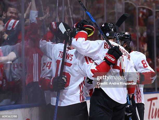 Corey Perry celebrates with Jonathan Toews, Jay Bouwmeester and Drew Doughty of Team Canada after scoring a first period goal on Team USA during the...