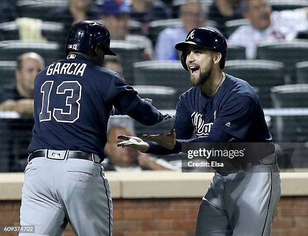 Ender Inciarte of the Atlanta Braves congratulates teammate Adonis Garcia after Garcia hit a three run home run in the seventh inning against the New...