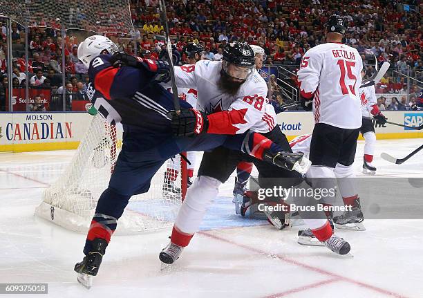 Brent Burns of Team Canada pushes Zach Parise of Team USA off the play during the second period during the World Cup of Hockey tournament at the Air...