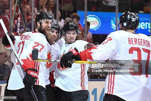 Patrice Bergeron celebrates with Alex Pietrangelo, John Tavares and Sidney Crosby of Team Canada after scoring a second period goal on Team USA...