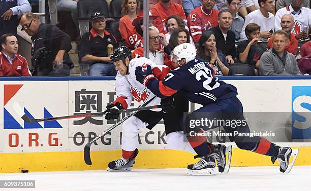 Ryan Getzlaf of Team Canada battles for the puck with Ryan McDonagh during the World Cup of Hockey 2016 at Air Canada Centre on September 20, 2016 in...