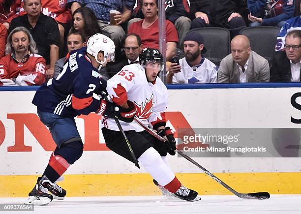 Brad Marchand of Team Canada stickhandles the puck with pressure from Matt Niskanen of Team USA during the World Cup of Hockey 2016 at Air Canada...