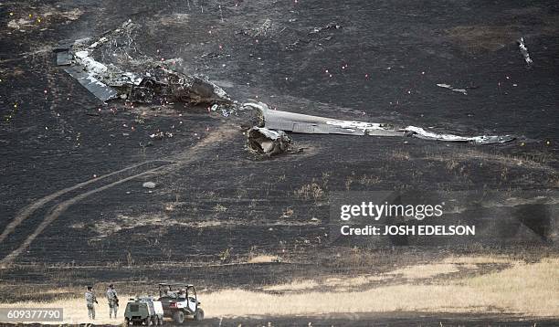 Members of the military investigate the site where an Air Force U-2 crashed in Sutter, California on September 20, 2016. A US pilot was killed and...