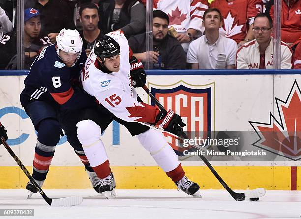Ryan Getzlaf of Team Canada stickhandles the puck with pressure from Joe Pavelski of Team USA during the World Cup of Hockey 2016 at Air Canada...