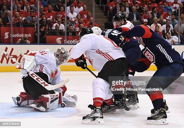 Carey Price makes a save with Shea Weber of Team Canada and James Van Riemsdyk of Team USA battling in front during the World Cup of Hockey 2016 at...